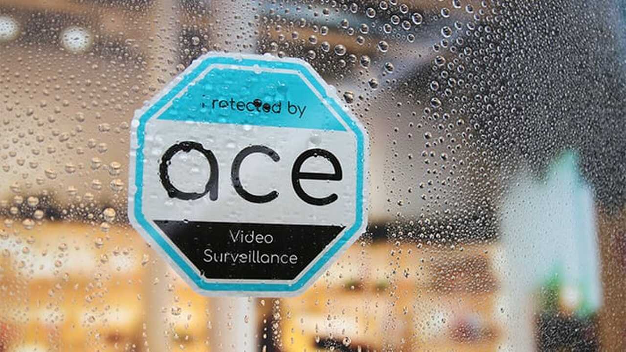 Die cut front adhesive sticker with ace design applied to a window