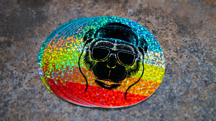Stack of round glitter stickers with monkey design on a table