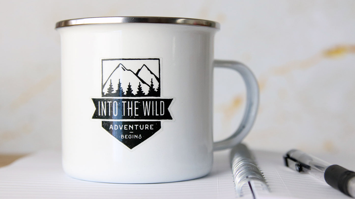 Clear sticker with adventure design printed onto clear vinyl applied to a white mug
