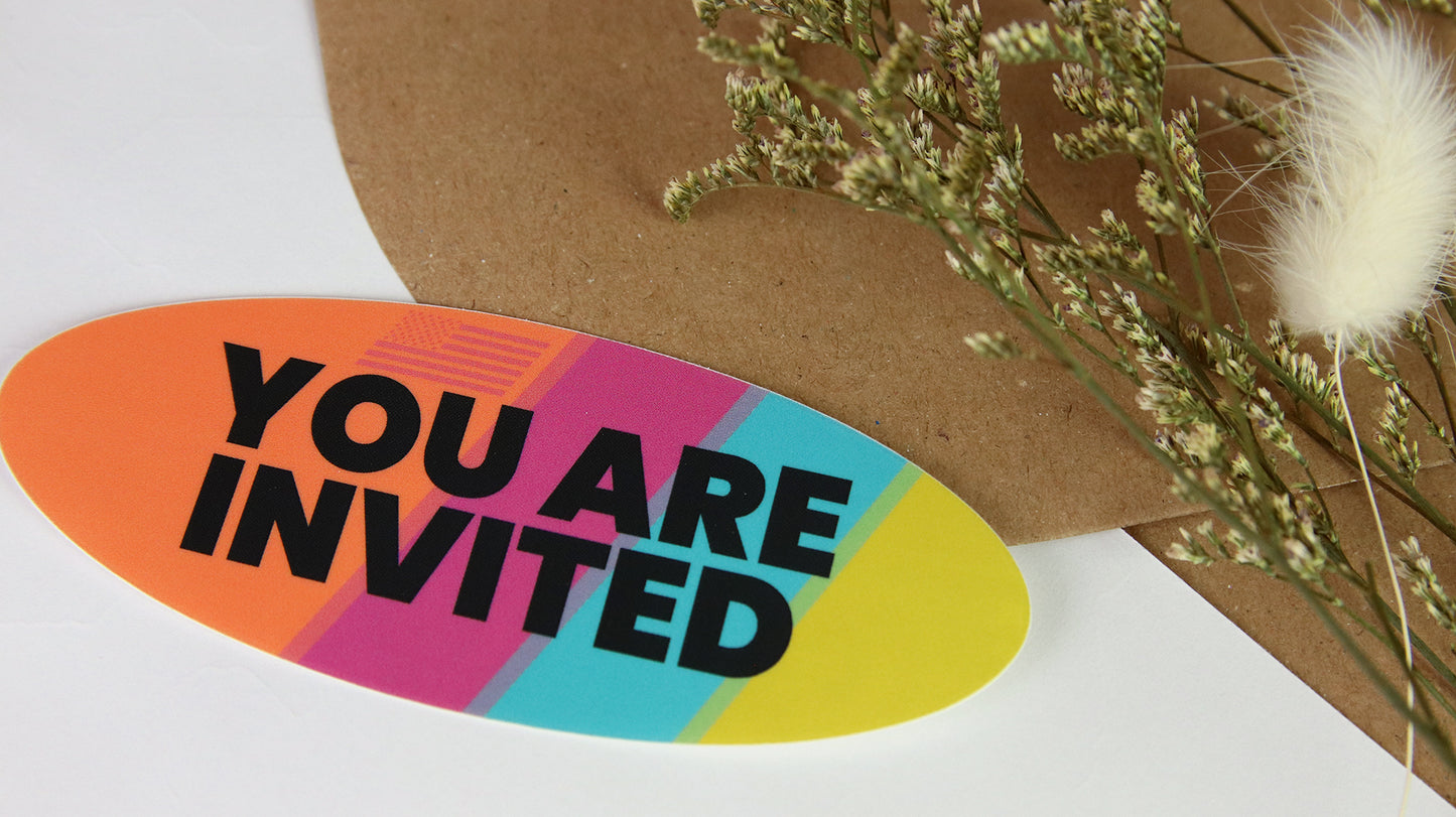 White vinyl oval sticker with rainbow colours and you are invited design applied to seal an envelope