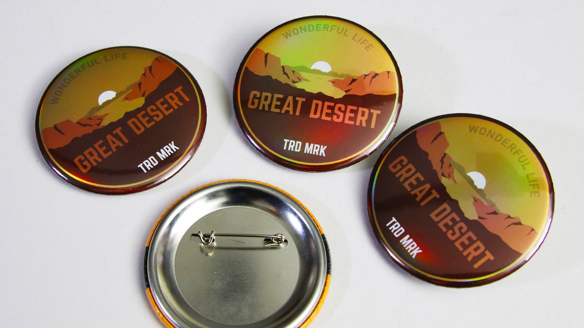 4 great desert logos printed on holographic 58mm (2.25 inch) button badges