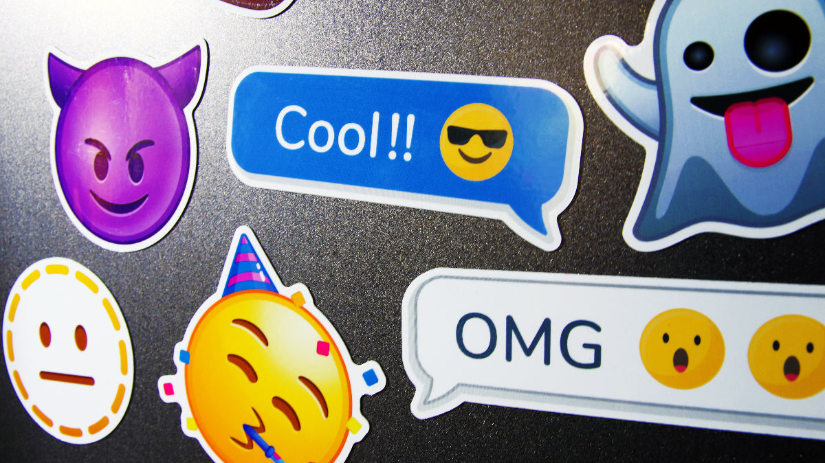 Several emoji magnets printed on white applied to a fridge