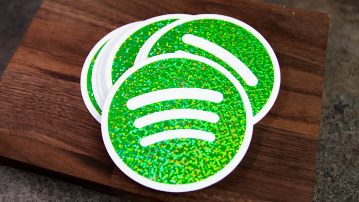 Stack of circle glitter sticker with green Spotify logo