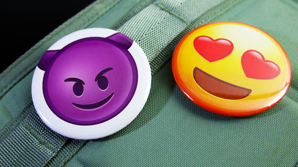 A love and a devil emoji printed on 2 badges 58mm (2.25 inches) large