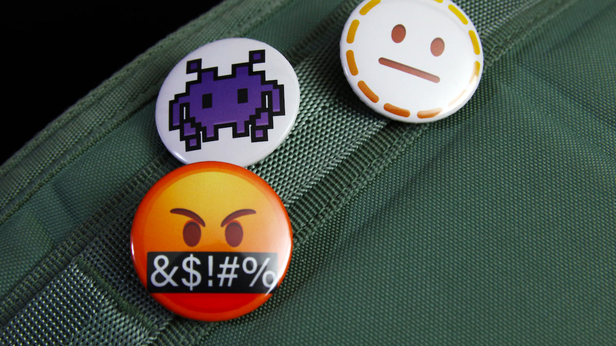Angry space invader emoji button badges printed on white 32mm (1.25 inch) buttons