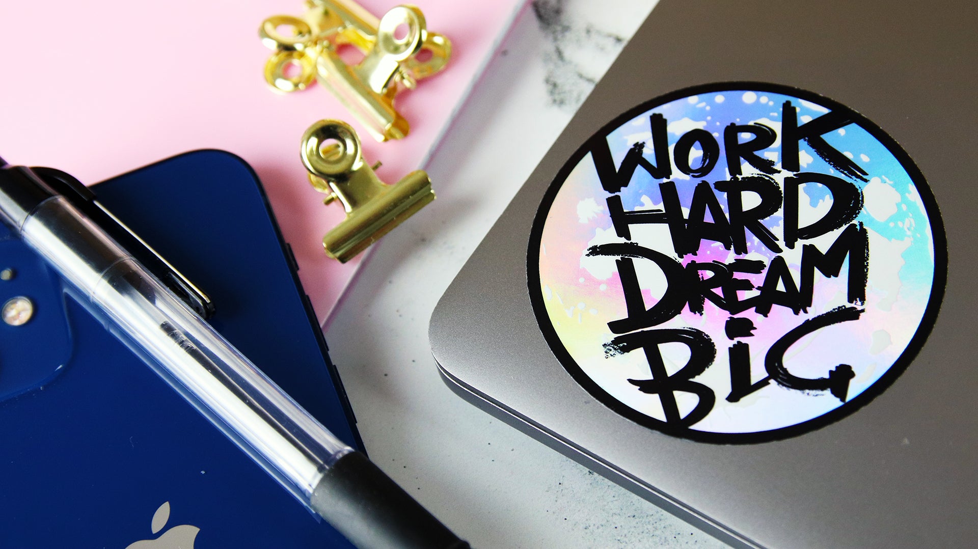 Circle holographic sticker with wirk hard dream big design applied to a laptop