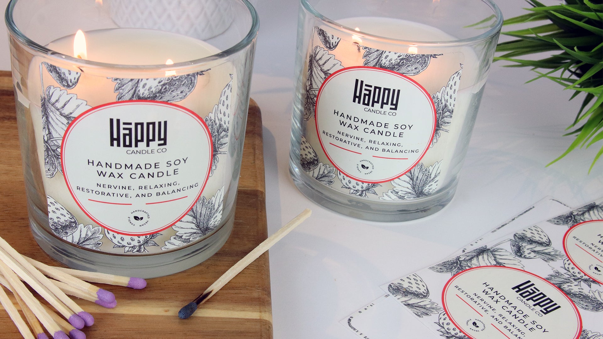Clear eco friendly compostable labels with flower design applied to handmade soy wax candles
