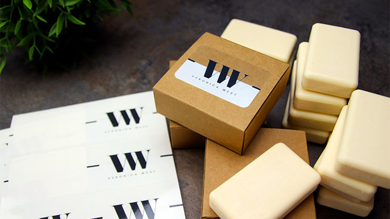 Clear labels with rounded corners applied to cardboard soap boxes