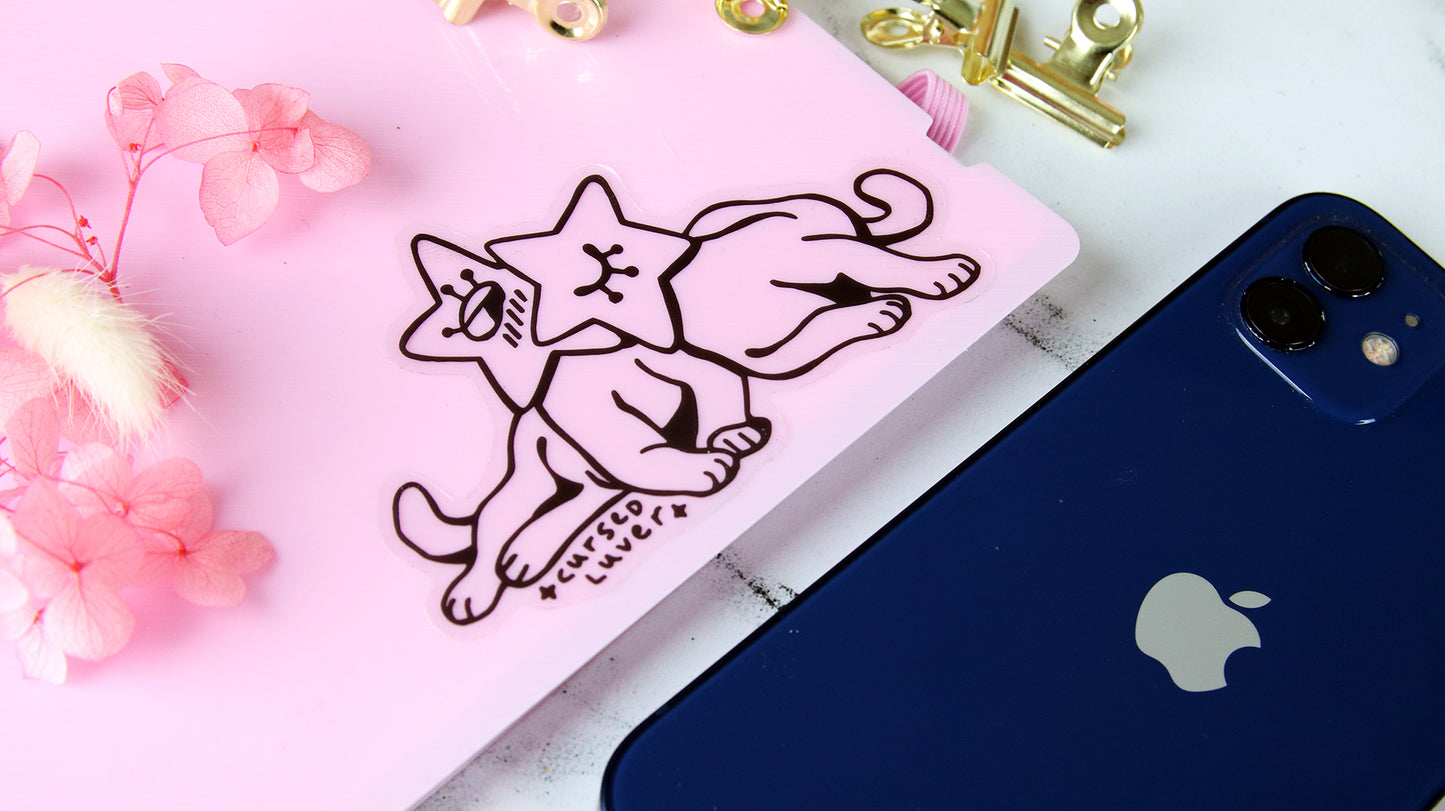 Clear vinyl stickers with cat art applied to a light pink notebook