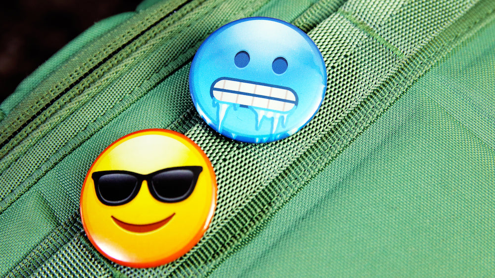 Cool emoji button badges printed on 37mm (1.5-inch) badge casings pinned to a backpack