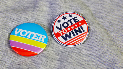 Custom button badges with campaign designs including a vote badge