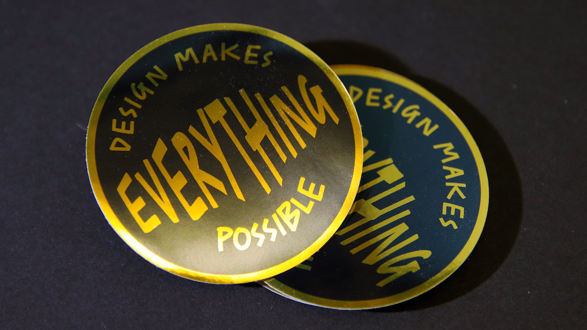 Design makes everything possible gold sticker piles