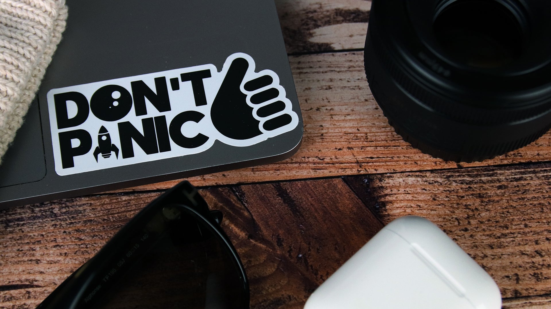 Die cut black label with don’t panic design applied to a black laptop