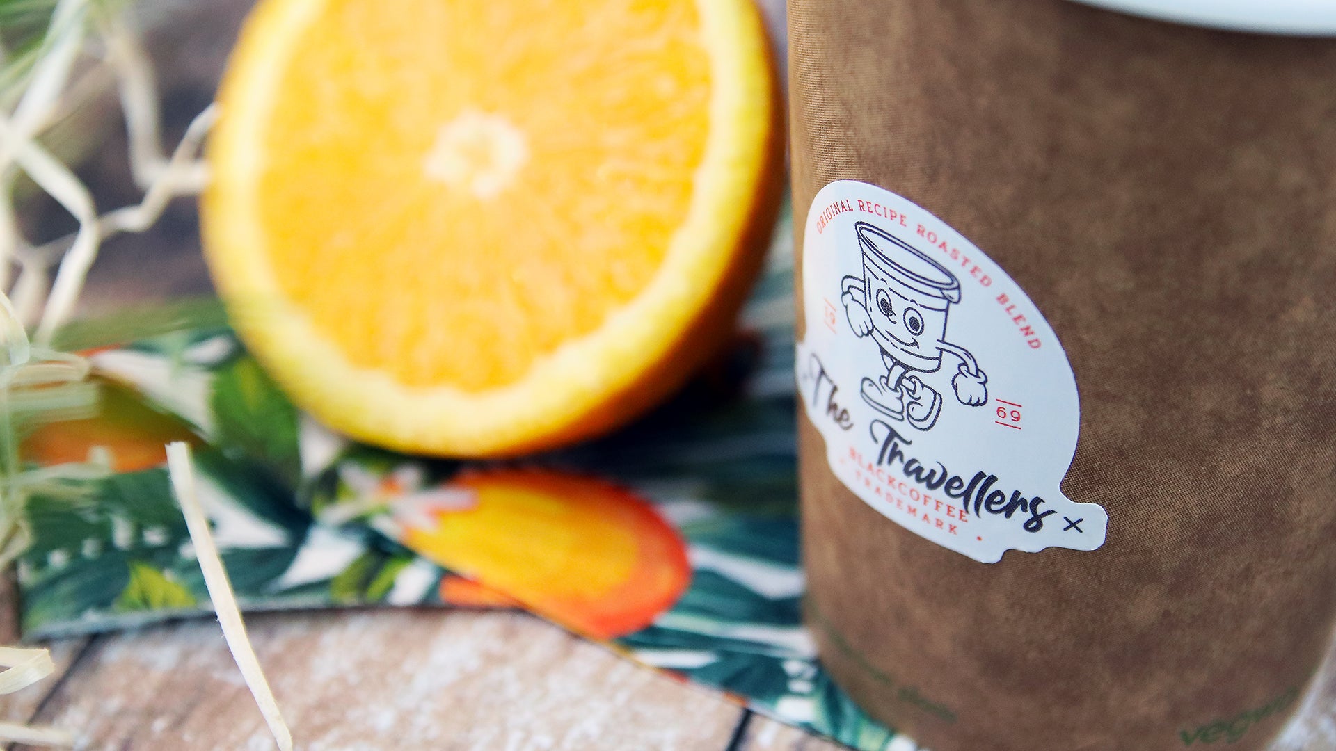 Die-cut eco-friendly label applied to brown paper coffee cup
