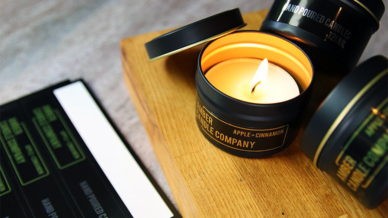 Mirror gold labels applied to black tin candles