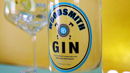 Oval clear label with gin logo applied to a clear gin bottle