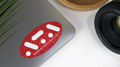 Oval glitter label with red ATA logo applied to a silver laptop