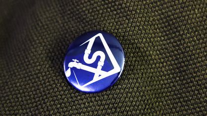 Promotional button badge with a local plumbing logo