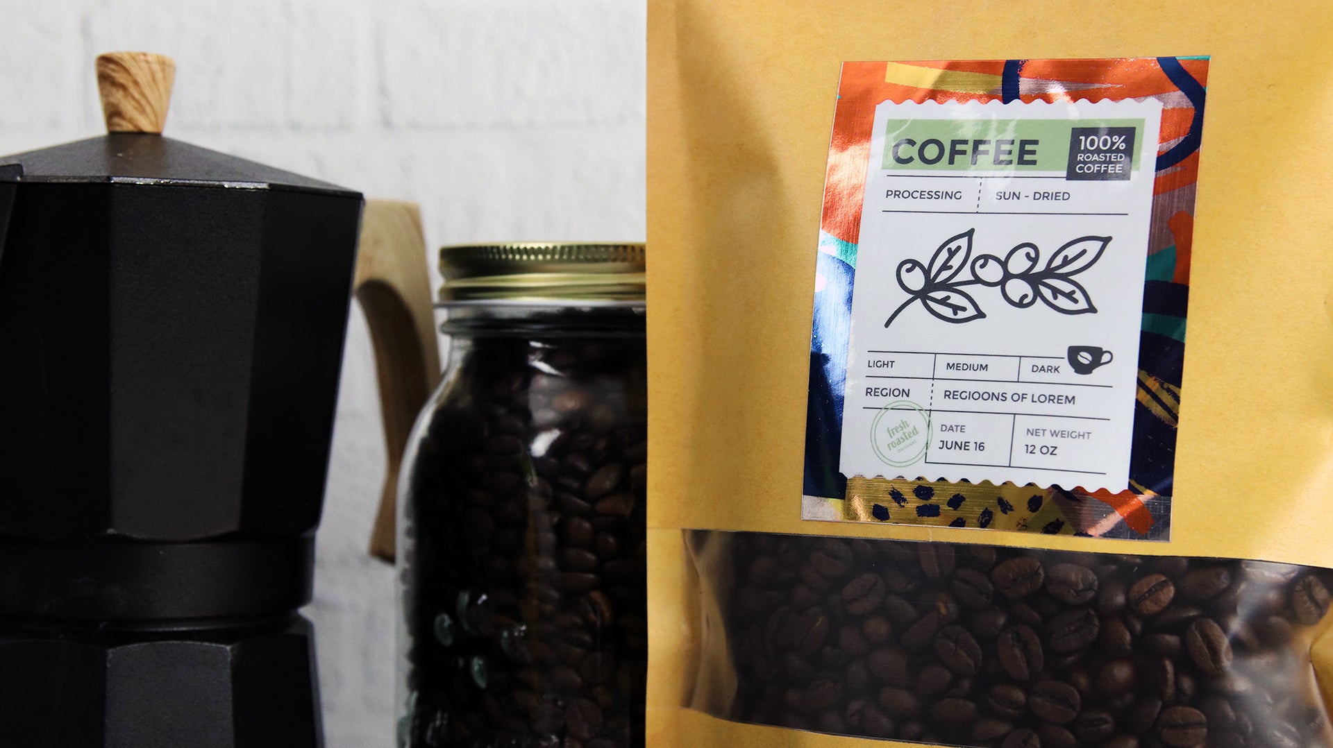 Rectangle mirror silver label applied to a bag of coffee next to a jar of coffee beans and an espresso maker