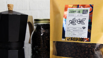 Rectangle mirror silver label applied to a bag of coffee next to a jar of coffee beans and an espresso maker