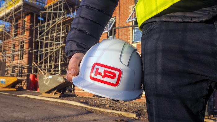 Rounded corner heavy duty label with logo applied to a hard hat