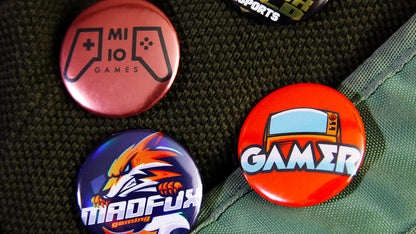 Various 37mm (1.5 inch) button badges pinned to clothes and a bag