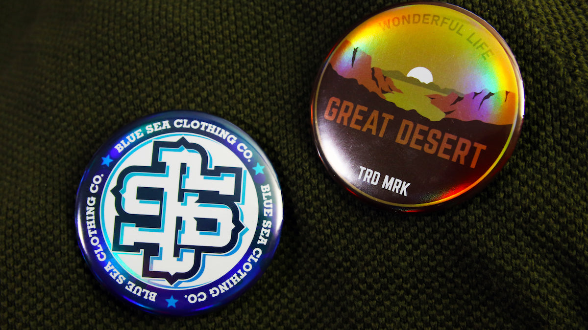 Various custom holographic 58mm (2.25 inch) button badges
