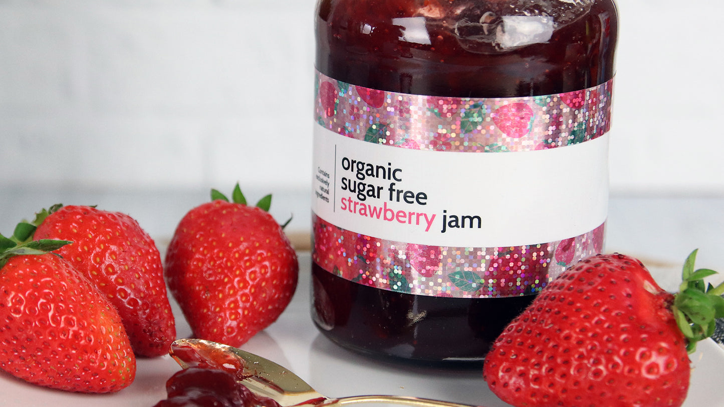 Glitter sticker applied to strawberry jam jar on a white plate
