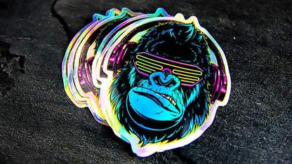 Stack of die cut holographic stickers with cool monkey design on a table