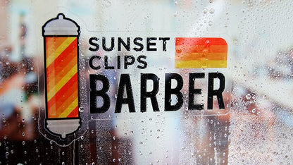 Sunset clips barber die cut front adhesive sticker on the inside of a window in the rain