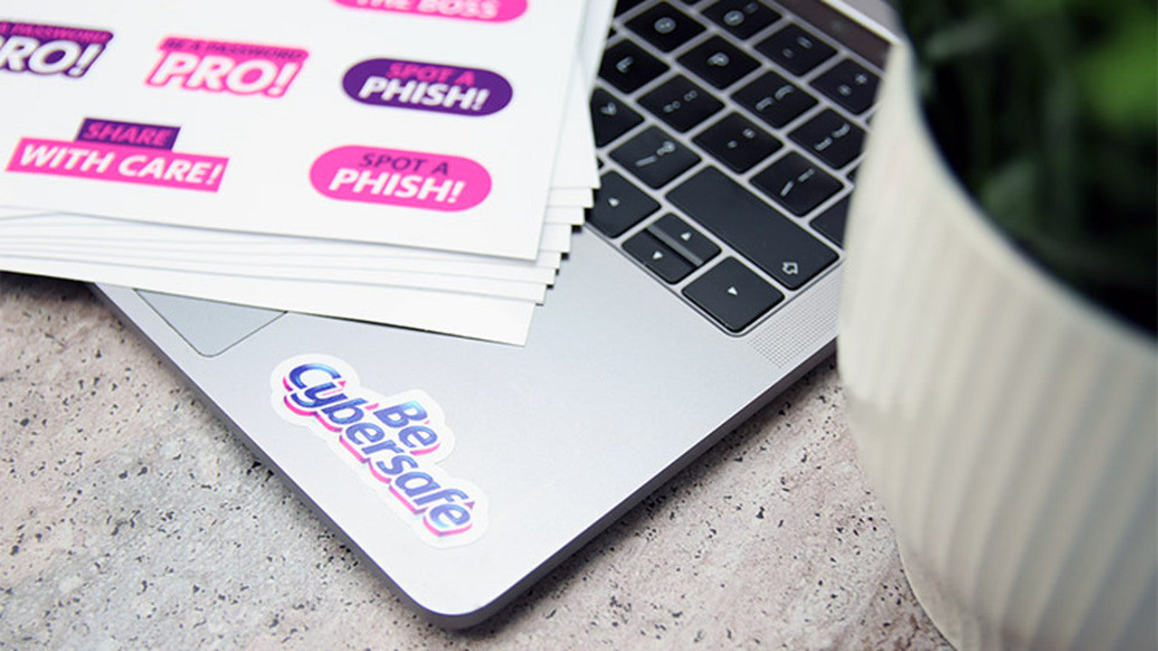 White vinyl sheet labels with one design applied to a silver laptop