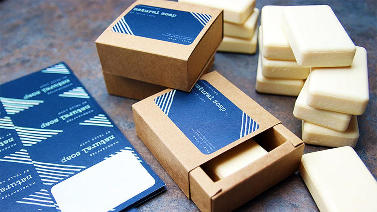 Biodegradable paper labels with rounded corners applied to a cardboard soap box