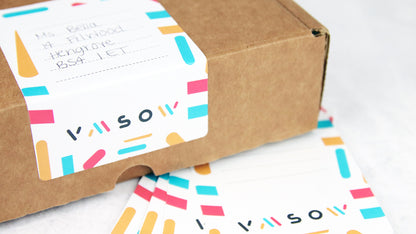 Biodegradable paper samples with rounded corners applied to a cardboard box used as an address label