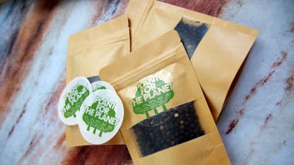 Circle eco-friendly clear stickers with plant for the planet logo applied to bags with seeds