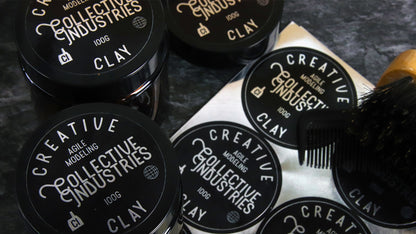 Circle mirror silver cosmetic labels applied to black tins containing hair care