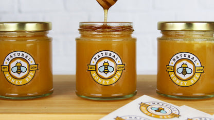Clear vinyl labels applied to three different honey jars
