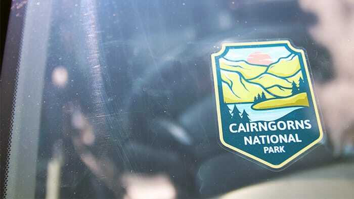 Custom shaped window label in a car windscreen with national park branding