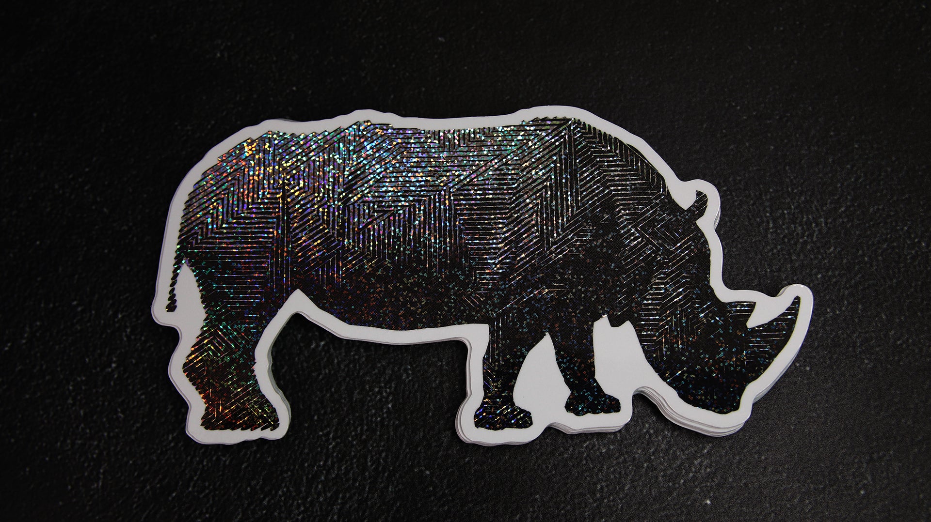 Die cut eco-friendly glitter samples with a dark rhino design