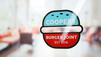 Die cut front adhesive sticker with burger joint logo applied to a window