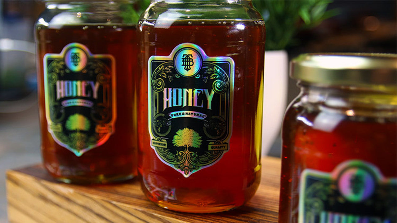Die cut holographic labels applied to honey jars