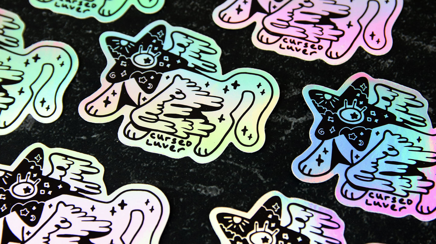 Die cut holographic samples with cat art design on a black table