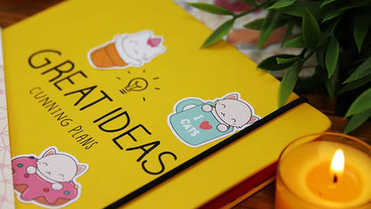 Die cut stickers printed onto biodegradable paper with several designs applied to yellow note book
