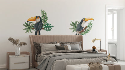 Die cut wall stickers with toucan design applied to a wall behind a bed