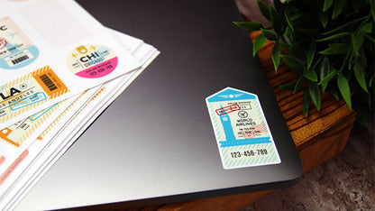Die cut white vinyl sheet labels peeled with one design applied to a laptop