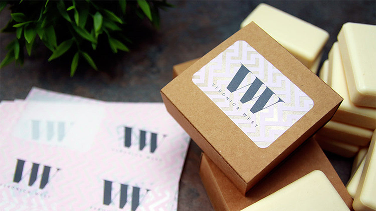 Eco-friendly clear labels with rounded corners applied to a cardboard soap box