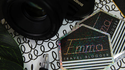 Eco-friendly glitter logo stickers die cut with travel blogger design on a notebook