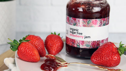 Glitter sample applied to strawberry jam jar on a white plate