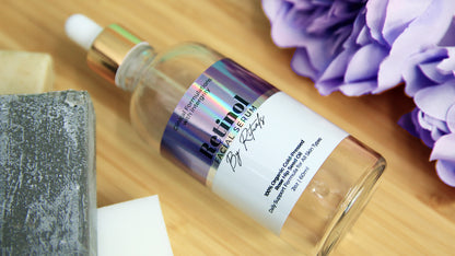 Glossy holographic label with retional facial serum logo applied to a clear cosmetics bottle