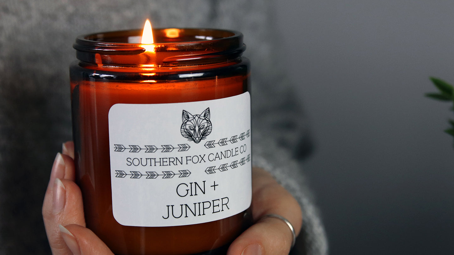 Hand-held amber candle branded with a white vinyl sticker with rounded corners