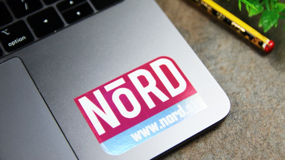 Holographic Nord die cut sticker applied to a laptop